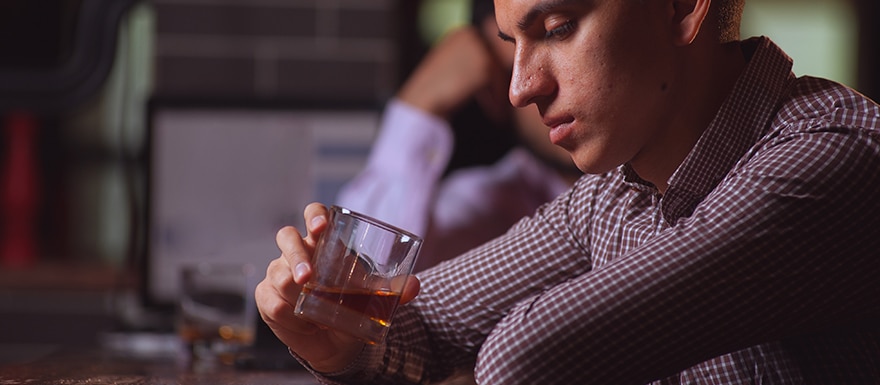 Man drinking liquor at bar