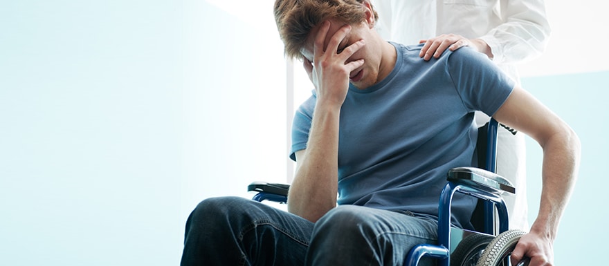 Upset young man in wheelchair